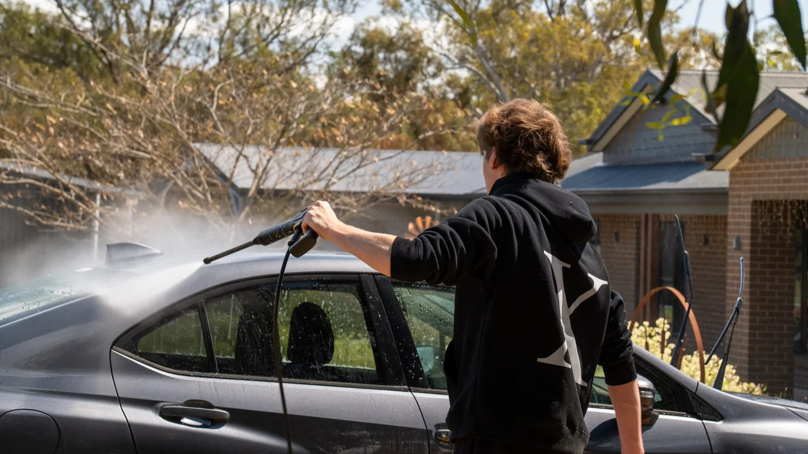 JC Details pressure washing a car